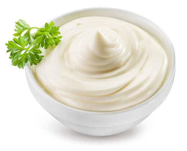Homemade mayonnaise in a white bowl on white background. File contains clipping path.