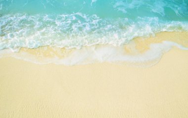 Güneşli kumsalda deniz dalgası. Yukarıdan görüntüle.
