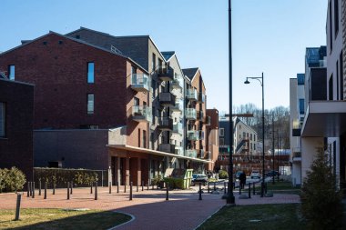 Vilnius, Lithuania - February 27, 2022: Paupys district of Vilnius - modern residential buildings and modern architecture on a sunny day. clipart