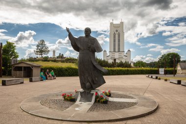 Siluva, Lithuania - June 15, 2024: Statue of a pope John Paul II in front of Holy Virgin Mary's Apparition Chapel in Siluva. clipart