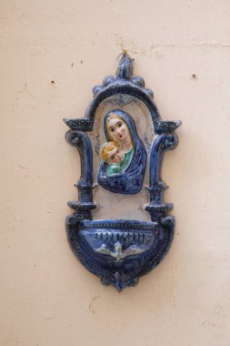 Malta 'nın Senglea kentindeki bir binanın duvarına Madonna ve Çocuk' u betimleyen süslü mavi ve beyaz seramik bir türbe asıldı.