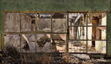 Abandoned storefront in a small town's business district. Only rubble left.