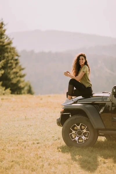 Pretty Young Woman Relaxing Terrain Vehicle Hood Countryside — Stock Photo, Image