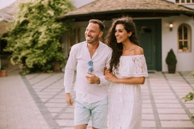 Handsome young couple walking in the backyard