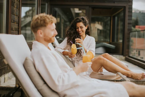 Handsome Young Couple Relaxing Beds Drinking Fresh Orange Juice Outdoor — Stockfoto