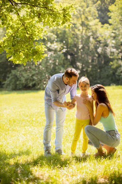 stock image Happy young family with cute little daughter having fun in park on a sunny day