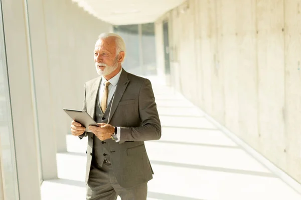 Handsome Mature Businessman Standing Digital Tablet Office Corridor — Stock Photo, Image