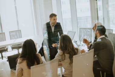 Handsome young businessman presenting results to his coleagues in the office