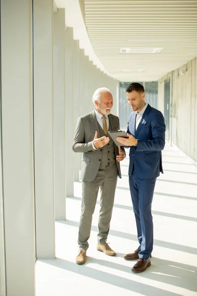 Handsome Mature Businessman His Young Colleague Discussing Finantial Report Digital — Stock Photo, Image