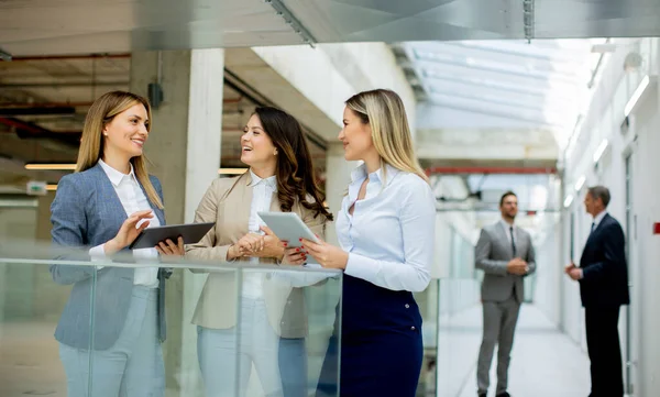 Three Pretty Young Business Women Digital Tablets Discussing Business Ideas — Stock Photo, Image