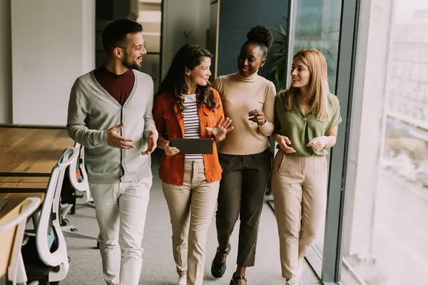 stock image Young multiethnic startup team walking at the modern office