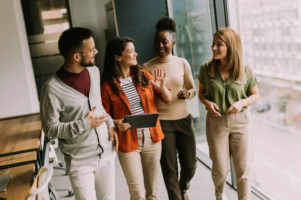 stock image Young multiethnic startup team walking at the modern office