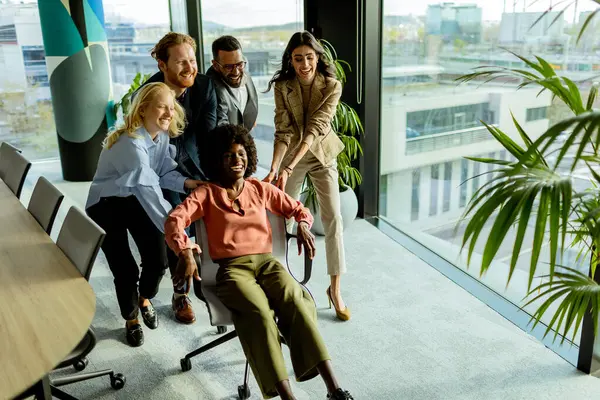 Team Coworkers Shares Moment Fun Racing Office Chair Amidst Well — Stock Photo, Image