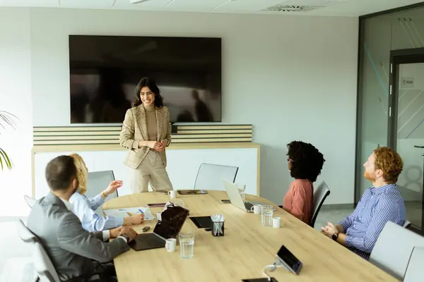 Poised Woman Presents Colleagues Meeting Her Expression Conveying Enthusiasm Leadership Stock Image