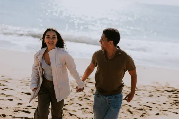 Smiling Couple Enjoys Carefree Run Sandy Shore Waves Gently Breaking — Stock Photo, Image