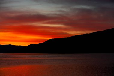 Büyüleyici günbatımı, Djerdap Vadisi 'nin sakin suları üzerinde canlı renkler bırakır. Etrafındaki tepelerin siluetleri çarpıcı bir manzara yaratır.