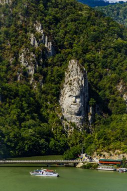 Orsova, Romania - September 2, 2021: Rock sculpture of Decebalus Rex, last king of Dacia. It is the tallest stone sculpture in Europe and the second in the world, made by Italian sculptor Mario Galeotti in 2004. clipart