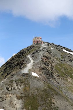 Bormio, Italy - July 7, 2013: Tibet Hut restaurant on the Stelvio Pass. It is a restaurand and bar that offer traditional cuisine from South Tyrol. clipart