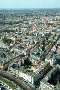 Alacakaranlıkta, Berlin 'in ufuk çizgisi tarihi binalar ve modern yapıların bir karışımını sergiliyor, canlı bir kentsel duvar halısı yaratıyor. Geniş görünüm şehrin dinamik özünü yakalar.. 