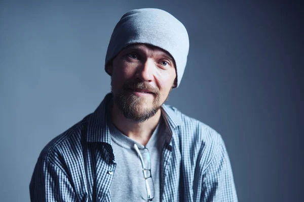 Cheerful casual man in beanie hat looking at camera