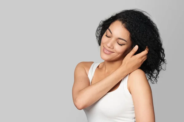 Nice Cheerful Mixed Race Girl Closed Eyes Touching Her Hair — Stock Photo, Image