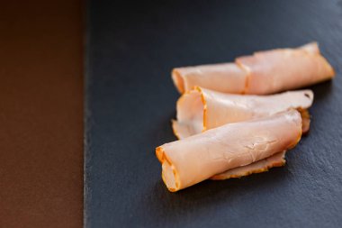 slice ham close up on stone board