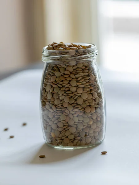 Raw Lentils Close Glass Jar Close White Background — Stock Photo, Image