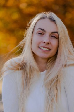 Beautiful Blonde Woman Close-Up Portrait in Fall Setting Outside - Autumn Elegance