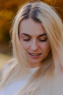 Beautiful Blonde Woman Close-Up Portrait in Fall Setting Outside - Autumn Elegance