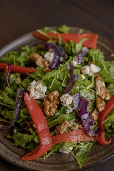 Winter Salad with Rucola, Red Onion, Canned Red Pepper, and Walnuts Close-Up