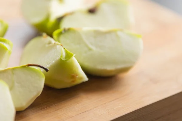 Fresh Organic Cut Green Apple Close Up on Wooden Board - Crisp and Wholesome Slice