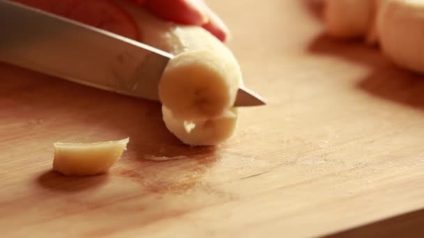 Close Woman Slicing Yellow Banana Wooden Cutting Board — Stock Video