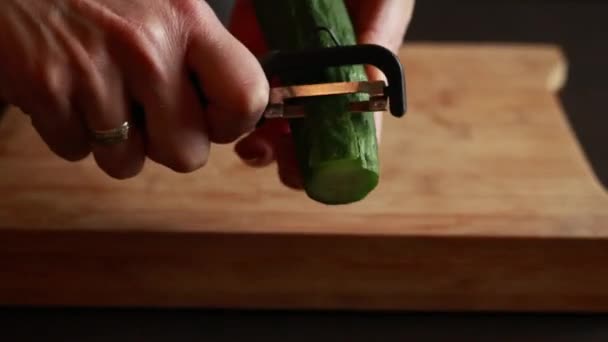 Hands Woman Delicately Peeling Fresh Cucumber Wooden Board Showcasing Preparation — Stockvideo