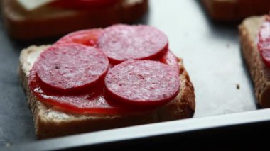 Women 's Hand Preparing Sandwich: Cheese on Bread with Tomato and Salmi - Close-Up Stock Video