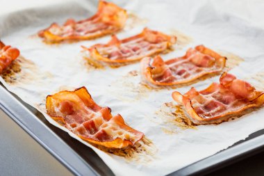 Parşömen kağıdında fırınlanmış pastırma şeritleri. Yakın plan.