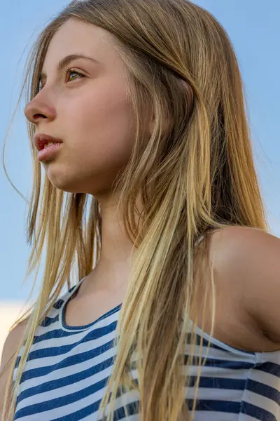 stock image  Cute Blonde Preteen in Blue and White Striped Dress, Sunlight Close-Up Portrait