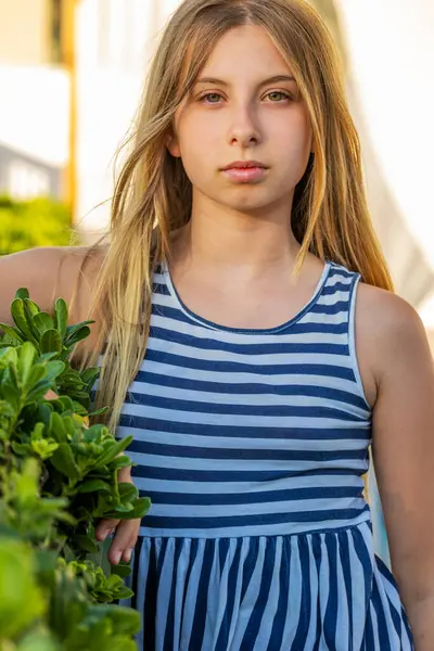 stock image  Cute Blonde Preteen in Blue and White Striped Dress, Sunlight Close-Up Portrait