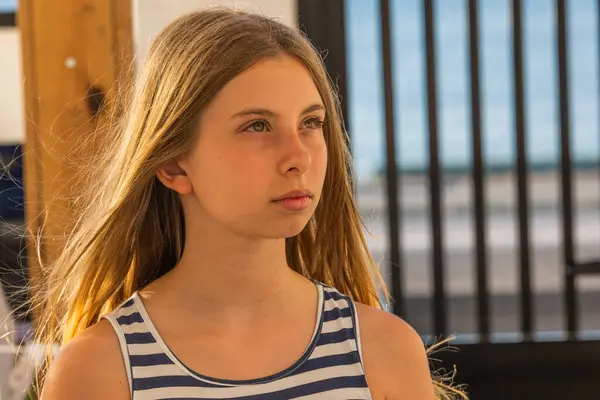 stock image  Cute Blonde Preteen in Blue and White Striped Dress, Sunlight Close-Up Portrait