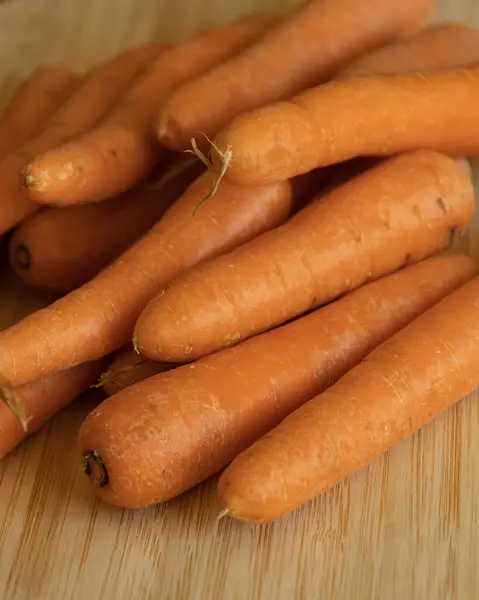 stock image Bunch of Fresh Organic Carrots on a Wooden Chopping Board Close-Up