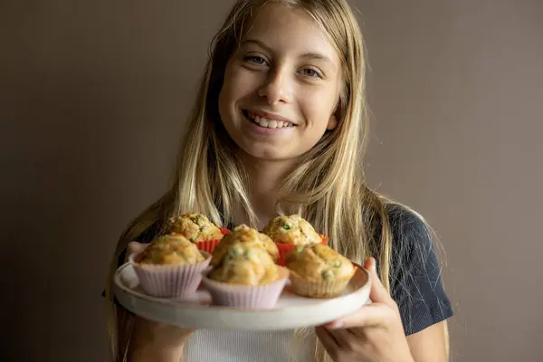 stock image  Kid Holding a Plate with Healthy Savory Muffin with Pea and Ham Close-Up