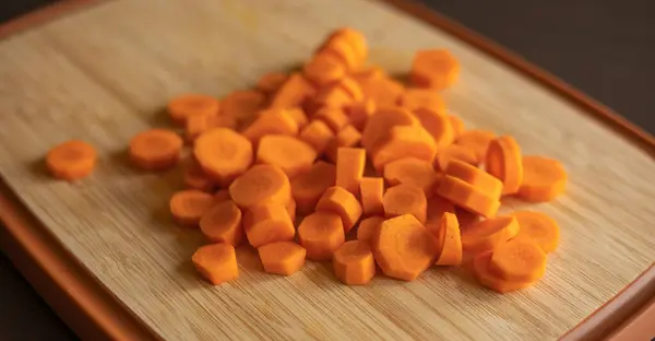 stock image  Slices of Fresh Carrots on Wooden Board Close-Up