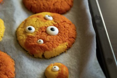 Freshly Baked Colorful Monster Cookies with Eyes for Halloween - Close-Up clipart