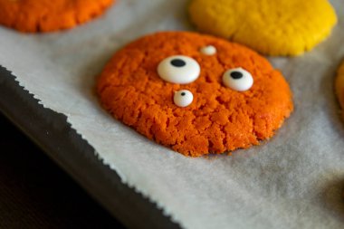 Freshly Baked Colorful Monster Cookies with Eyes for Halloween - Close-Up clipart