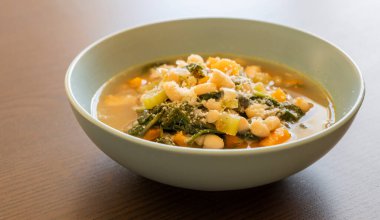 Delicious Italian White Bean Soup in a Blue Bowl  Close-Up clipart