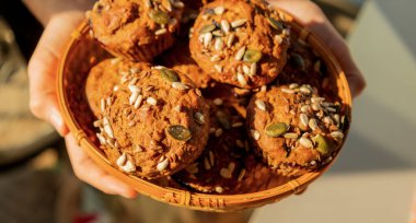 Close-up of freshly baked healthy muffins topped with a mix of seeds. Perfect for nutritious snacks, breakfast, and wholesome treats clipart