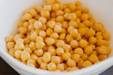 Cooked Chickpeas in a White Bowl Close-Up clipart