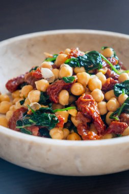 Healthy Salad with Chickpeas, Sun-Dried Tomatoes, and Spinach Close-Up clipart