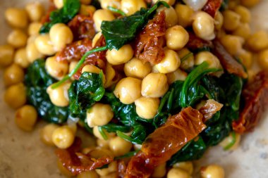 Healthy Salad with Chickpeas, Sun-Dried Tomatoes, and Spinach Close-Up clipart