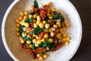 Healthy Salad with Chickpeas, Sun-Dried Tomatoes, and Spinach Close-Up clipart