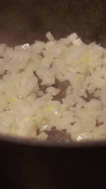  Tavada doğranmış soğan pişirmek.